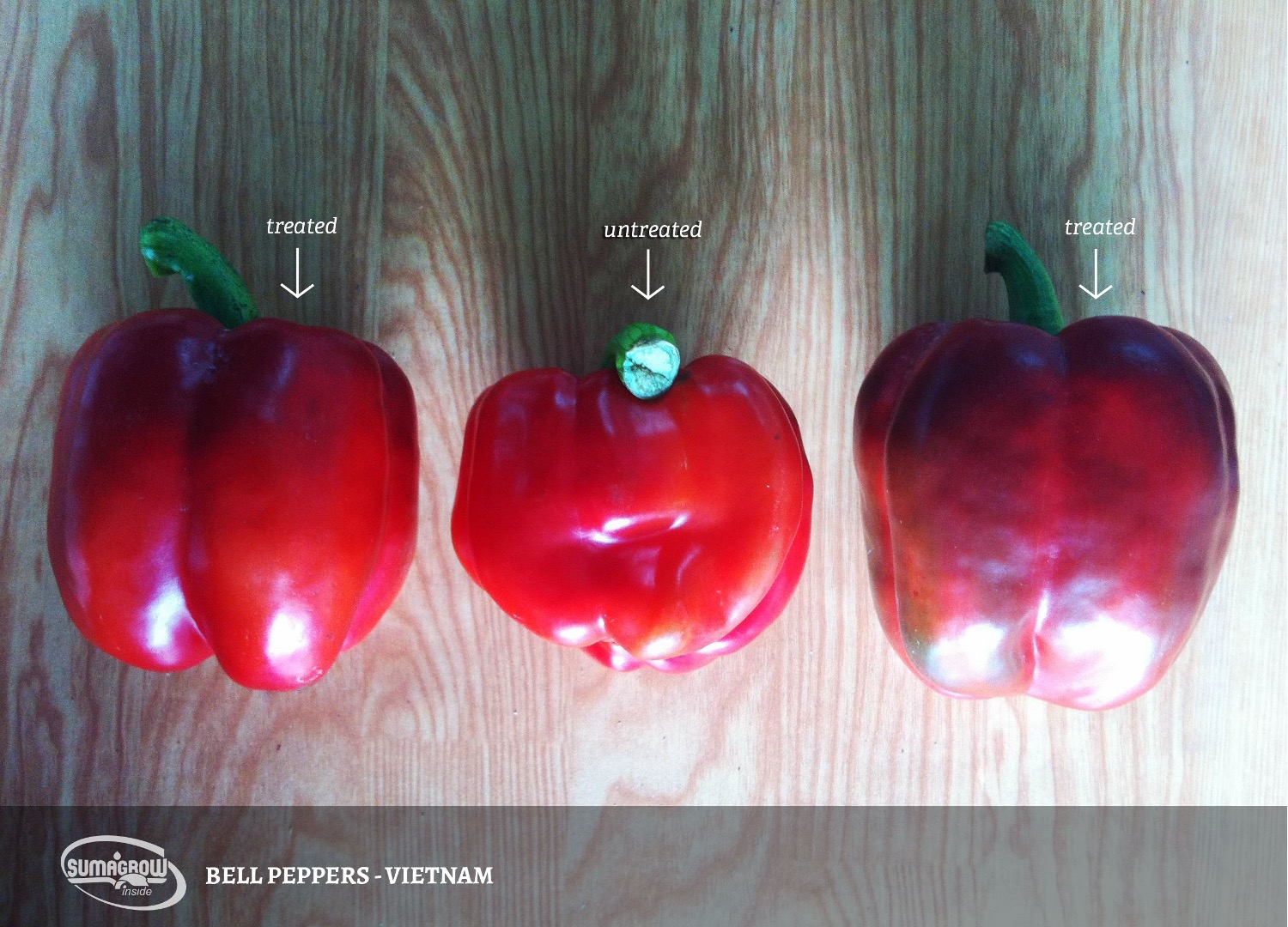 a group of red peppers on a wood surface